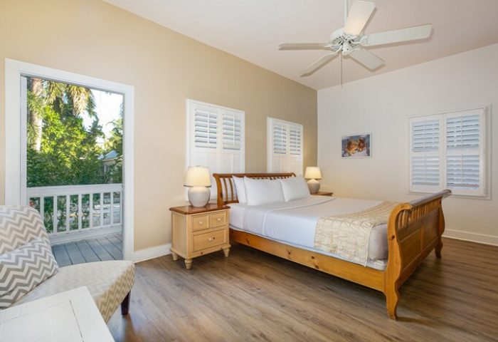 Paradise Inn adults-only gay-friendly hotel bedroom. Queen bed, ceiling fan, and balcony. A relaxing room for gay men's travel.