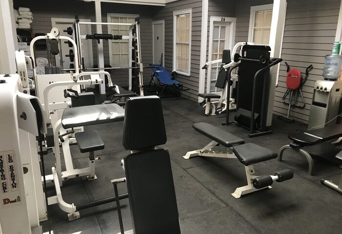 Gym at a gay-friendly hotel in New Orleans. Fitness equipment includes weight machines, benches, & water cooler. A great amenity for gay travelers.