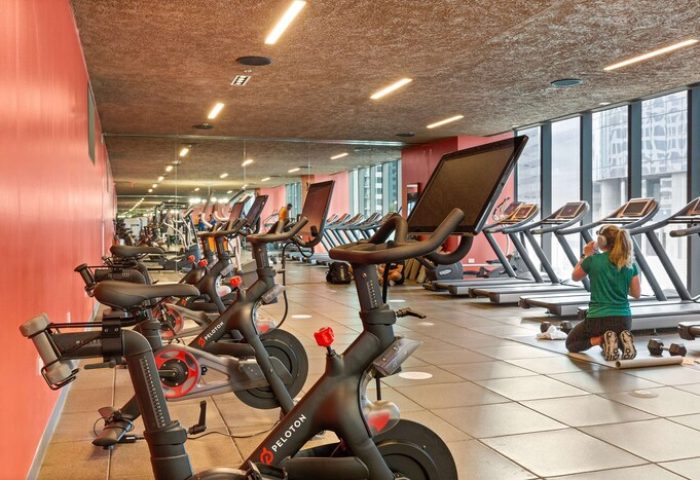 EAST Miami Gay-Friendly Hotel gym. Peloton bikes and treadmills offer a workout with a view. Modern fitness center for hotel guests.