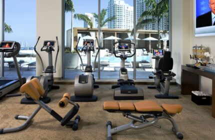 Kimpton EPIC Hotel gym with treadmills, bikes, and weights. Gay-friendly hotel fitness center overlooking the pool in Miami.