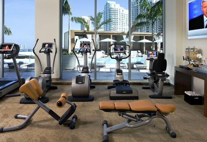 Kimpton EPIC Hotel gym with treadmills, bikes, and weights. Gay-friendly hotel fitness center overlooking the pool in Miami.