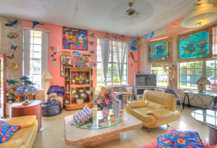 Interior of the James Hotel, a gay-friendly hotel. Living room with eclectic decor, colorful art, and comfortable seating. Inviting space.