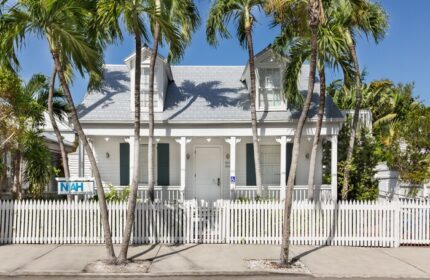 NYAH Key West Gay-Friendly Hotel: Quaint white building with a picket fence and palm trees. Adults-only lodging for gay travelers.