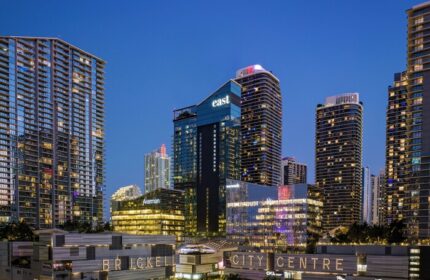 EAST Miami's Brickell City Centre at night. Gay-friendly hotel with modern architecture. Skyscrapers and bright lights define the skyline.