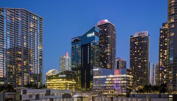 EAST Miami's Brickell City Centre at night. Gay-friendly hotel with modern architecture. Skyscrapers and bright lights define the skyline.