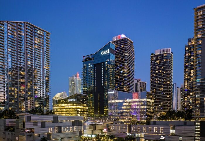 EAST Miami's Brickell City Centre at night. Gay-friendly hotel with modern architecture. Skyscrapers and bright lights define the skyline.