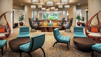Sheraton Waikiki Beach Resort lobby. Gay-friendly hotel lounge area with unique chairs, tables, and hanging cocoon seats. Relaxing space.