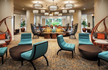 Sheraton Waikiki Beach Resort lobby. Gay-friendly hotel lounge area with unique chairs, tables, and hanging cocoon seats. Relaxing space.