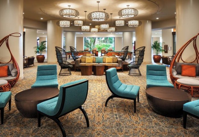 Sheraton Waikiki Beach Resort lobby. Gay-friendly hotel lounge area with unique chairs, tables, and hanging cocoon seats. Relaxing space.