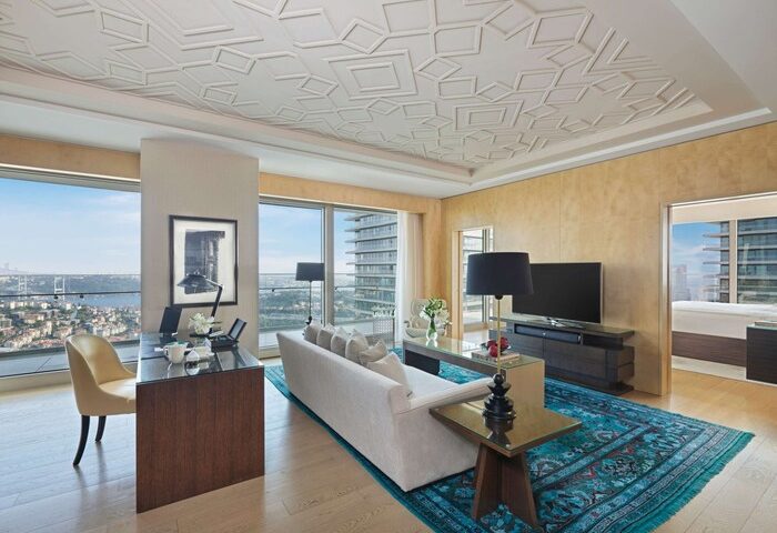 Raffles Istanbul Hotel room interior. Gay-friendly hotel offers luxury with city views, modern decor, and comfortable spaces. Ideal for gay travel.