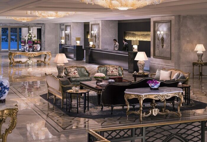 Shangri-La Bosphorus, Istanbul: Gay-friendly hotel lobby with ornate gold furniture, chandeliers, and marble floors. Reception desk visible.