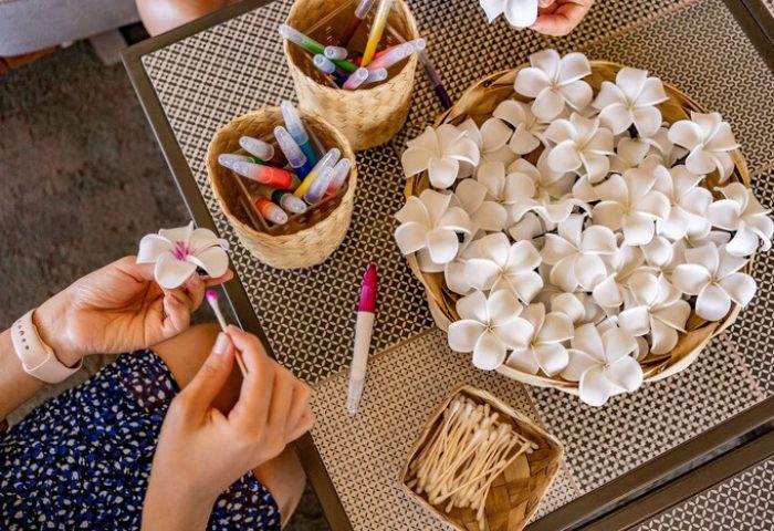OUTRIGGER Waikiki Beach Resort craft activity. Coloring white flowers with markers. Gay-friendly hotel with unique experiences.