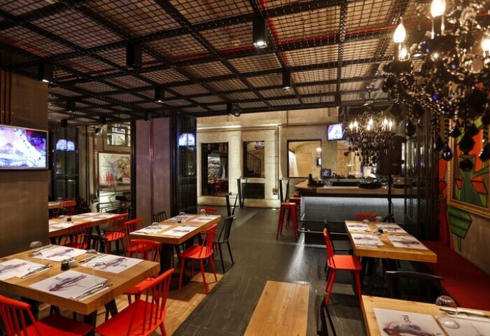 Hotel The Public, a special category, gay-friendly hotel. Interior view of the restaurant with tables, chairs, and bar area. Modern design.