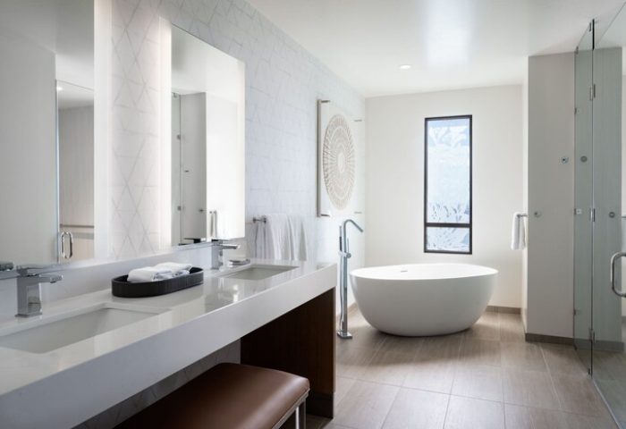 Waikiki Beach Marriott Resort & Spa bathroom. Modern design with double vanity, soaking tub, and glass shower. Gay-friendly hotel.