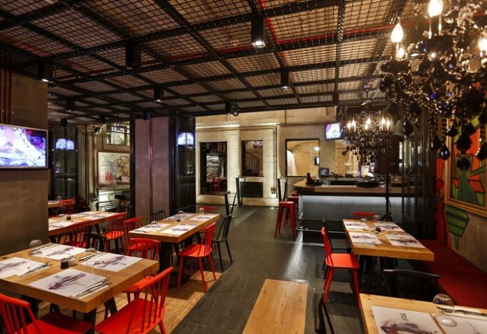 Hotel The Public, a special category, gay-friendly hotel. Interior view of the restaurant with tables, chairs, and bar area. Modern design.