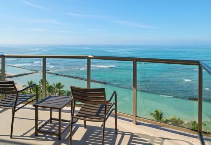 Aston Waikiki Circle Hotel balcony view. Gay-friendly hotel with ocean views in Honolulu. Chairs overlook the Pacific.