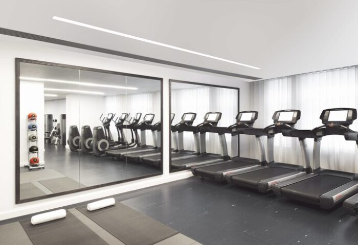 Gym at The London EDITION, a gay-friendly hotel. Treadmills, elliptical machines, yoga mats, and weights. Fitness center for gay travelers.