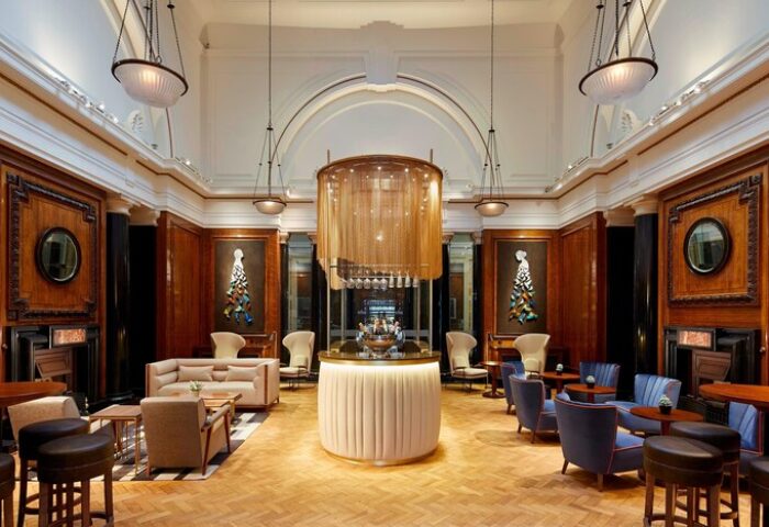 Interior of the London Marriott Hotel County Hall, a gay-friendly hotel. Features a bar area with a unique chandelier and stylish seating.
