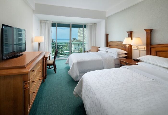 Sheraton Princess Kaiulani, gay-friendly hotel room. Two beds, balcony with ocean view. Comfortable travel accommodations for gay men.