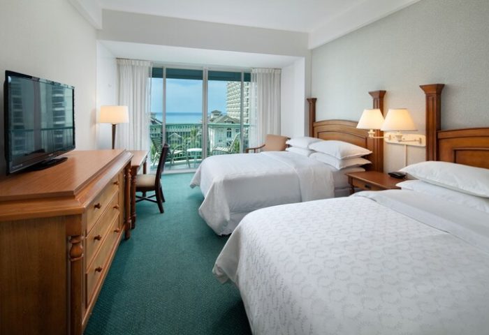 Sheraton Princess Kaiulani, gay-friendly hotel room. Two beds, balcony with ocean view. Comfortable travel accommodations for gay men.