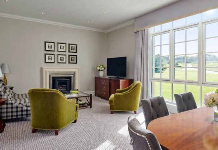 Fairmont St Andrews, Scotland: Gay-friendly hotel living room with golf course view. Elegant interior design, perfect for gay men's travel.