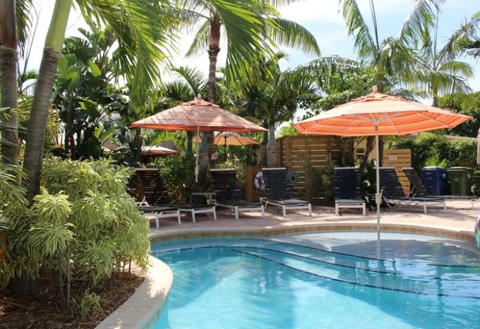Poolside view at The Cabanas Guesthouse & Spa, a gay men's resort. Lounge chairs and umbrellas offer relaxation in this gay-friendly hotel.