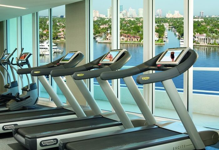 The Ritz-Carlton, Fort Lauderdale gay-friendly hotel gym. Treadmills face a scenic waterfront view. Fitness for gay men travelers.