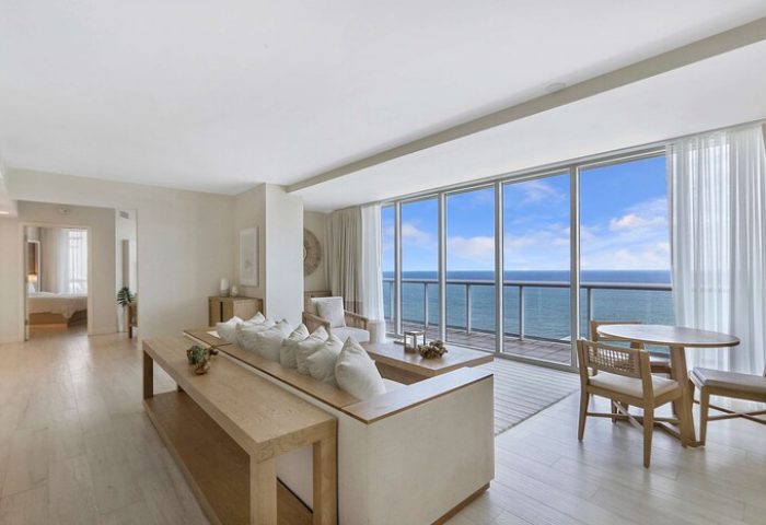 Hilton Fort Lauderdale Beach Resort suite with ocean view, a gay-friendly hotel. Living room with floor to ceiling windows. Modern, bright, and airy.