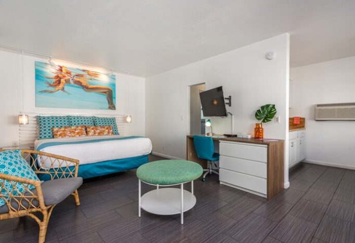 Nobleton Hotel room: Gay-friendly hotel with a bed, desk, TV, and kitchenette. Modern design for gay men's travel, comfortable and stylish.