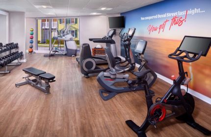 The Reach Key West gym with weights, treadmills, & stationary bike. You conquered Duval Street last night...You got this! Gay-friendly hotel.