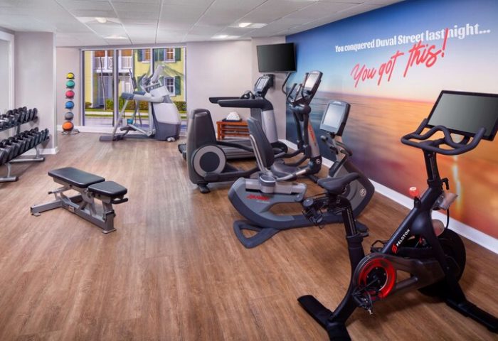 The Reach Key West gym with weights, treadmills, & stationary bike. You conquered Duval Street last night...You got this! Gay-friendly hotel.