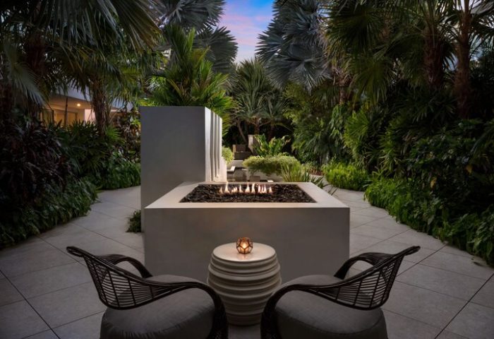 H2O Suites adults only gay-friendly hotel patio. Fire pit with chairs, lush tropical plants, and a romantic ambiance. Perfect for gay travel.