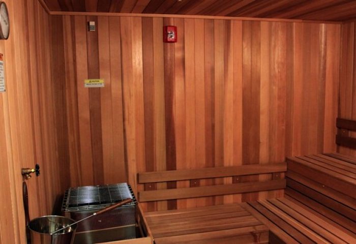Gay-friendly hotel sauna at Hotel Gaythering, an all-adults welcome gay hotel. Wooden benches, walls, and ceiling create a warm, relaxing space.