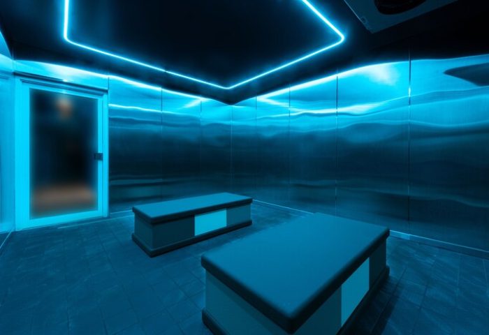 The Standard Miami gay-friendly hotel sauna. Blue neon lights illuminate metal walls and benches. A modern, sleek design for gay travelers.