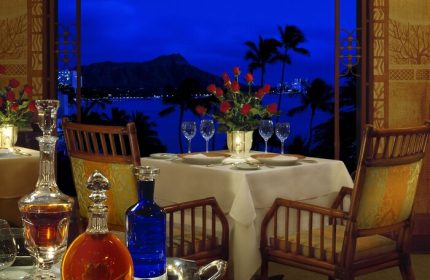 Halekulani Hotel dining table at night with Diamond Head view. Gay-friendly hotel for gay men travelers. Fine dining experience.