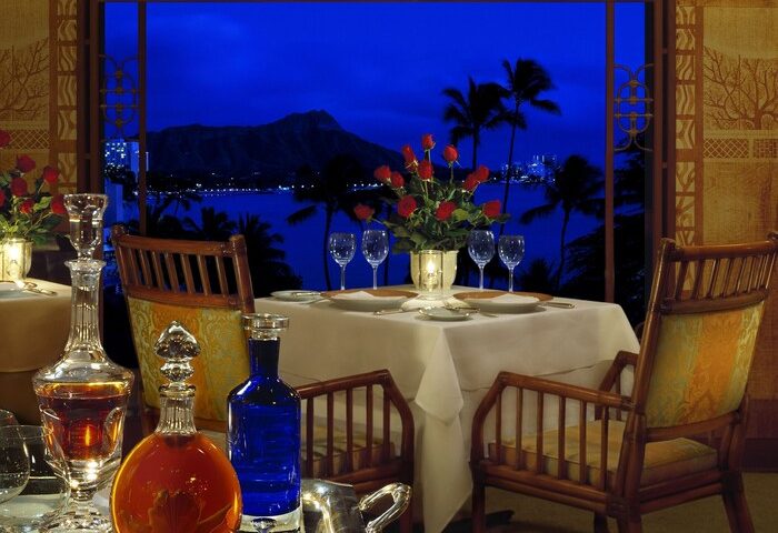 Halekulani Hotel dining table at night with Diamond Head view. Gay-friendly hotel for gay men travelers. Fine dining experience.