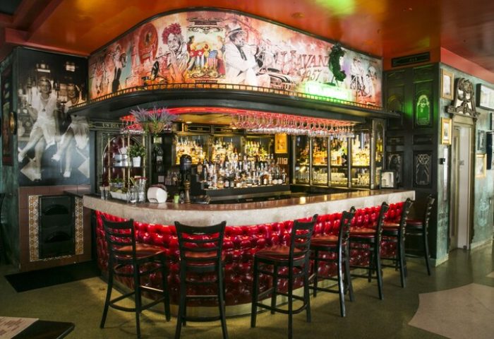 Hotel Breakwater South Beach's gay-friendly bar. A stylish bar with red leather seating and a mural. A great spot for gay men travelers.