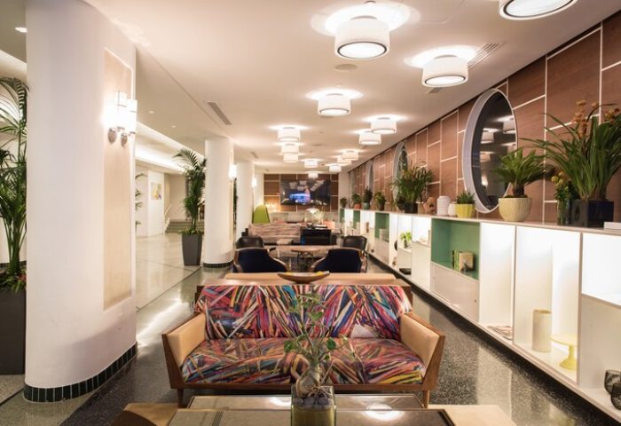 Royal Palm South Beach Miami lobby. Gay-friendly hotel lounge area with colorful sofas, plants, and modern lighting. Tribute Portfolio Resort interior.