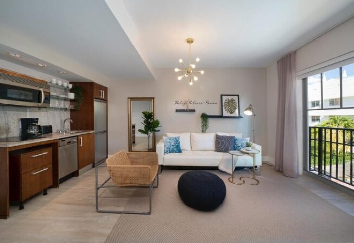 Strand Ocean Drive Suites' gay-friendly hotel room. Modern decor, kitchenette, balcony view. Perfect for gay travel in Miami Beach.