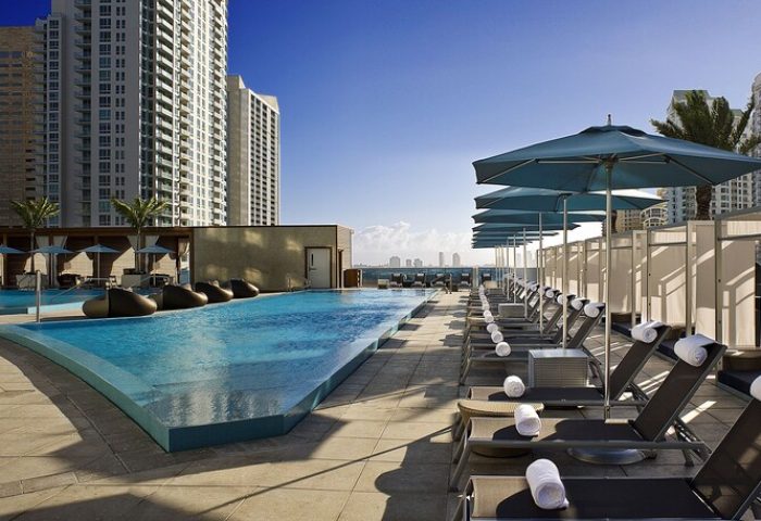 Kimpton EPIC Hotel's rooftop pool and lounge chairs. A gay-friendly hotel in Miami. Perfect for gay men travel advice.
