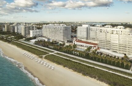 Aerial view of Four Seasons Hotel at The Surf Club, a gay-friendly hotel. Beachfront property with palm trees and ocean views. Miami gay travel.