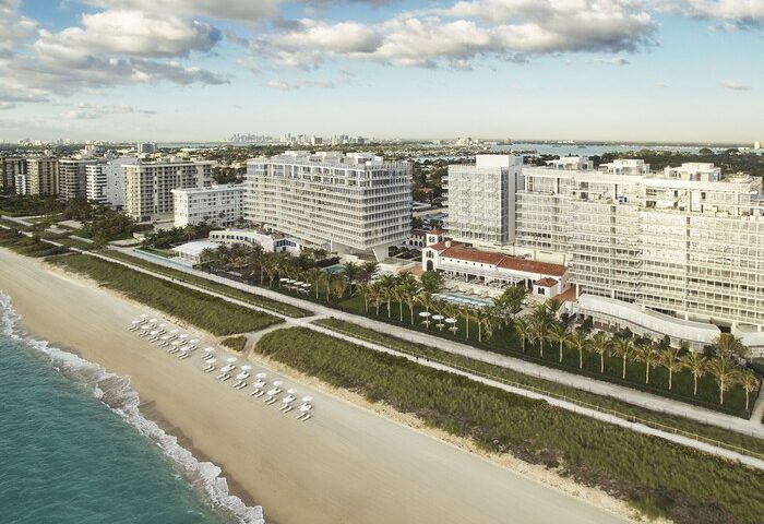 Aerial view of Four Seasons Hotel at The Surf Club, a gay-friendly hotel. Beachfront property with palm trees and ocean views. Miami gay travel.