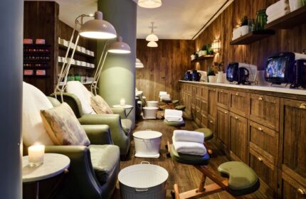 Soho House Istanbul's spa area: Leather chairs, footstools, and TVs line the wood-paneled walls of this gay-friendly hotel.
