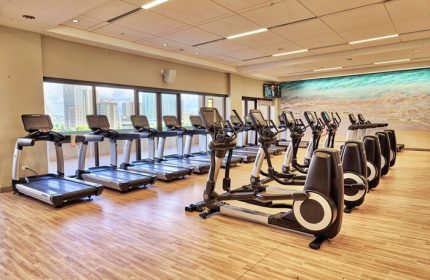 Hilton Hawaiian Village Waikiki Beach Resort gym. Treadmills and elliptical machines. Gay-friendly hotel fitness center. Waikiki view.