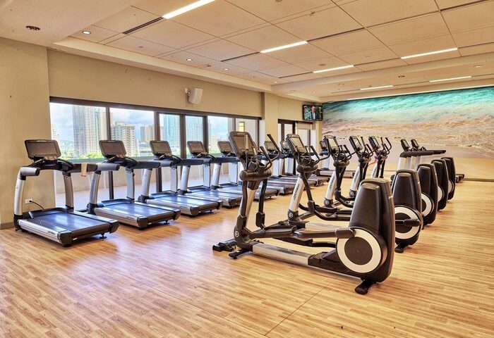 Hilton Hawaiian Village Waikiki Beach Resort gym. Treadmills and elliptical machines. Gay-friendly hotel fitness center. Waikiki view.