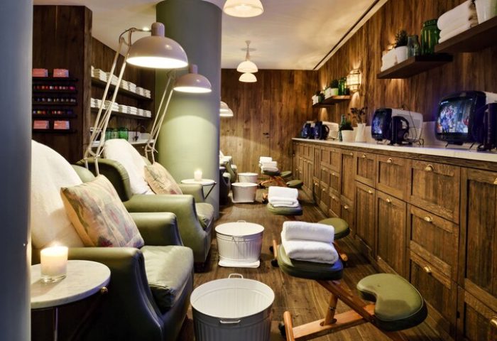 Soho House Istanbul's spa area: Leather chairs, footstools, and TVs line the wood-paneled walls of this gay-friendly hotel.
