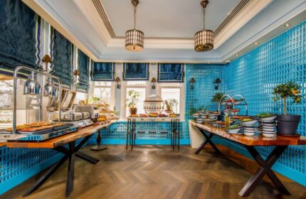 Hagia Sofia Mansions Istanbul breakfast buffet. Gay-friendly hotel with food, salads, and pastries. Blue decor, Curio Collection by Hilton.