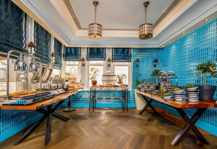 Hagia Sofia Mansions Istanbul breakfast buffet. Gay-friendly hotel with food, salads, and pastries. Blue decor, Curio Collection by Hilton.