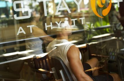 Gay-friendly Hyatt Regency Waikiki gym. Man works out. Waikiki Beach Resort and Spa fitness center. Travel advice for gay men.