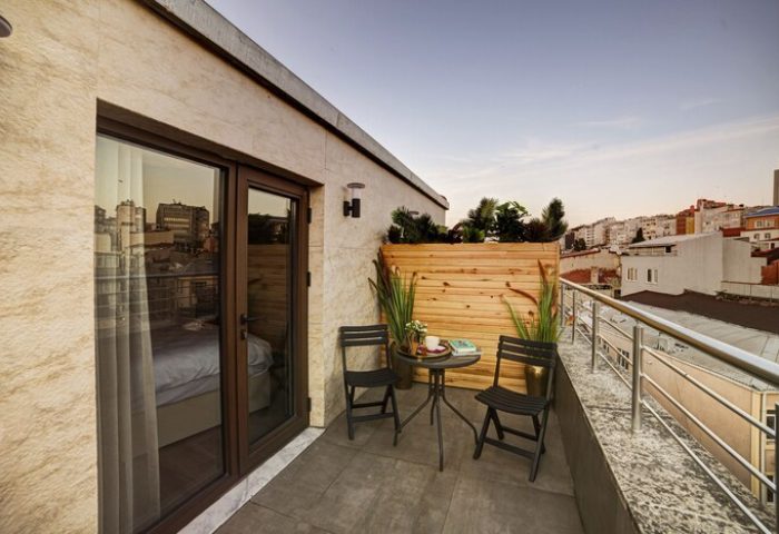The Fox Hotel's gay-friendly balcony view. Chairs and table on a private balcony. Gay travel accommodations. Hotel room with outdoor space.